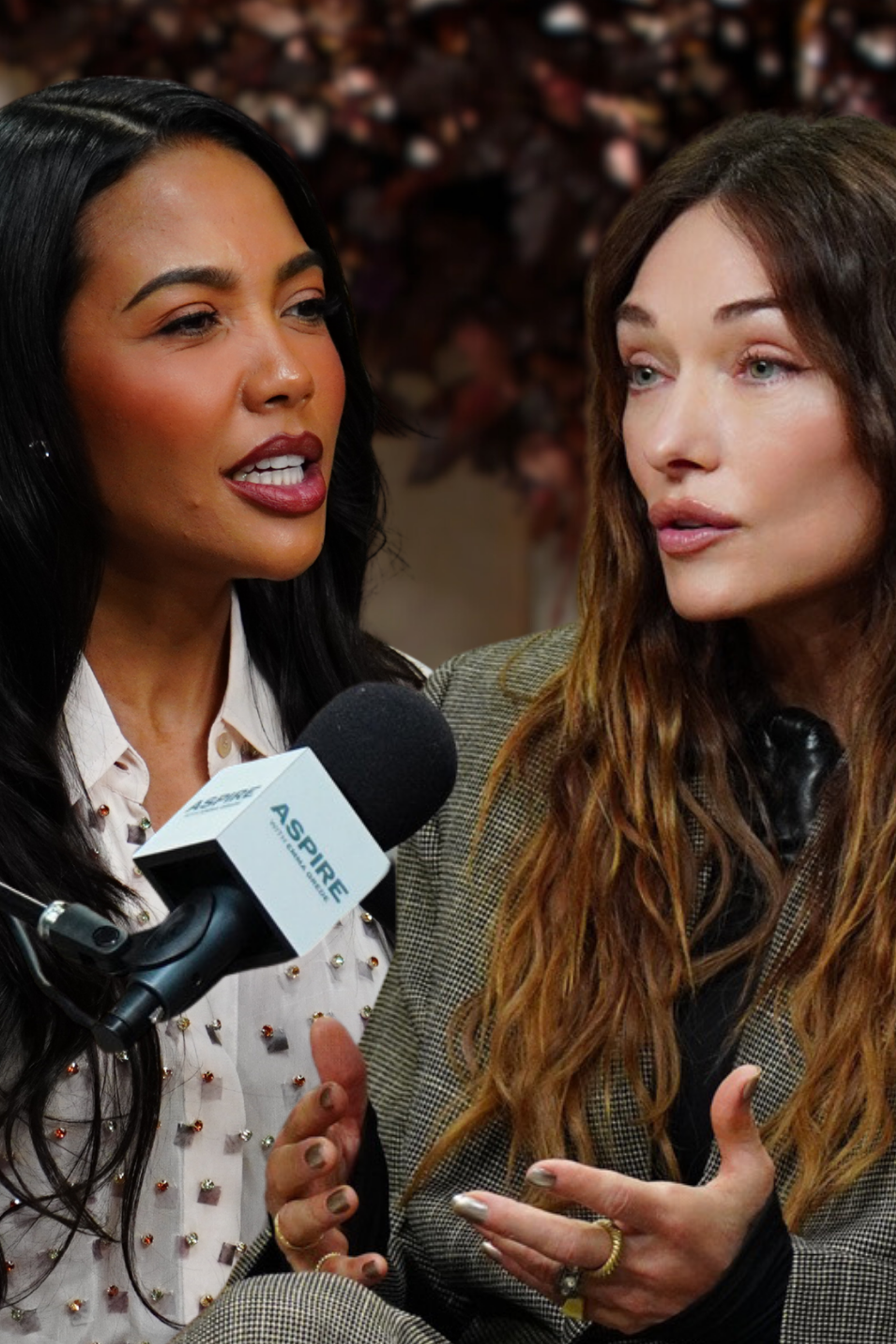 Two women, one speaking into a microphone and the other gesturing, engaged in conversation.
