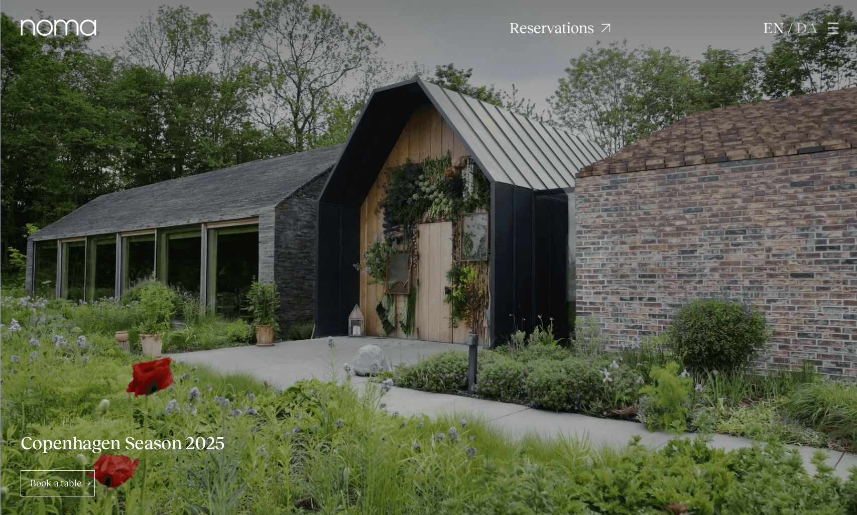 Noma Copenhagen website hero showing the restaurant entrance surrounded by gardens