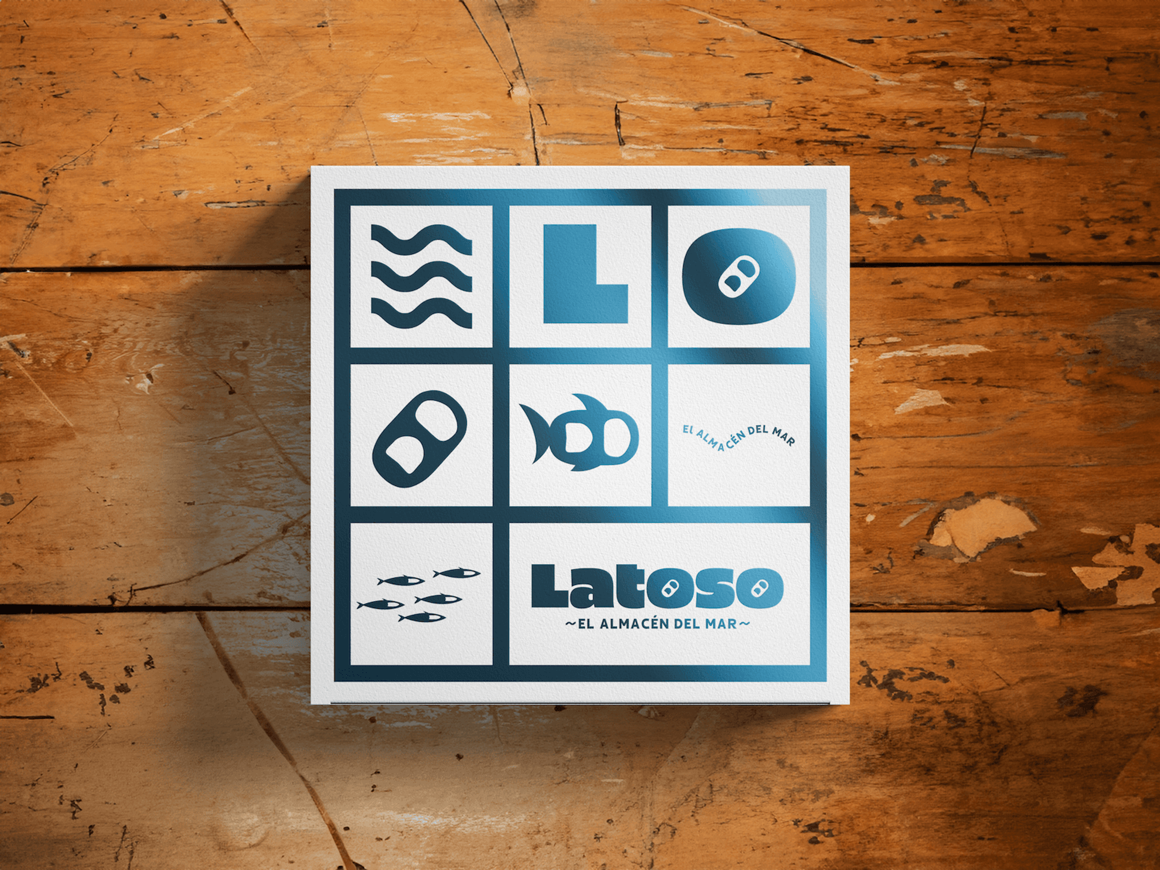 Square seafood brand poster with nine icon tiles and Latoso El Almacen del Mar logo placed on a wooden table.