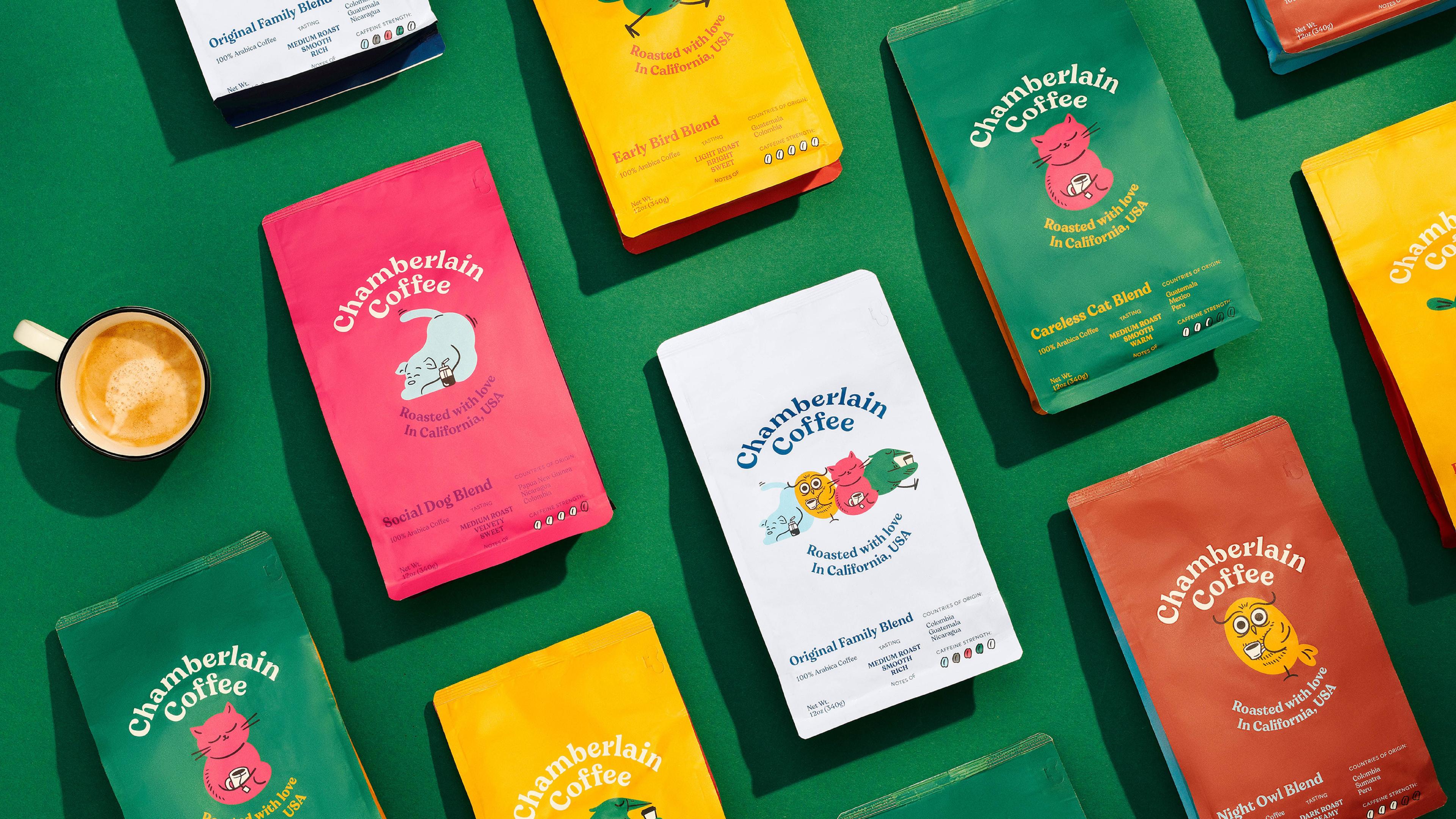 Colorful Chamberlain Coffee bags laid out on a green background, showcasing the influencer coffee brand’s playful packaging