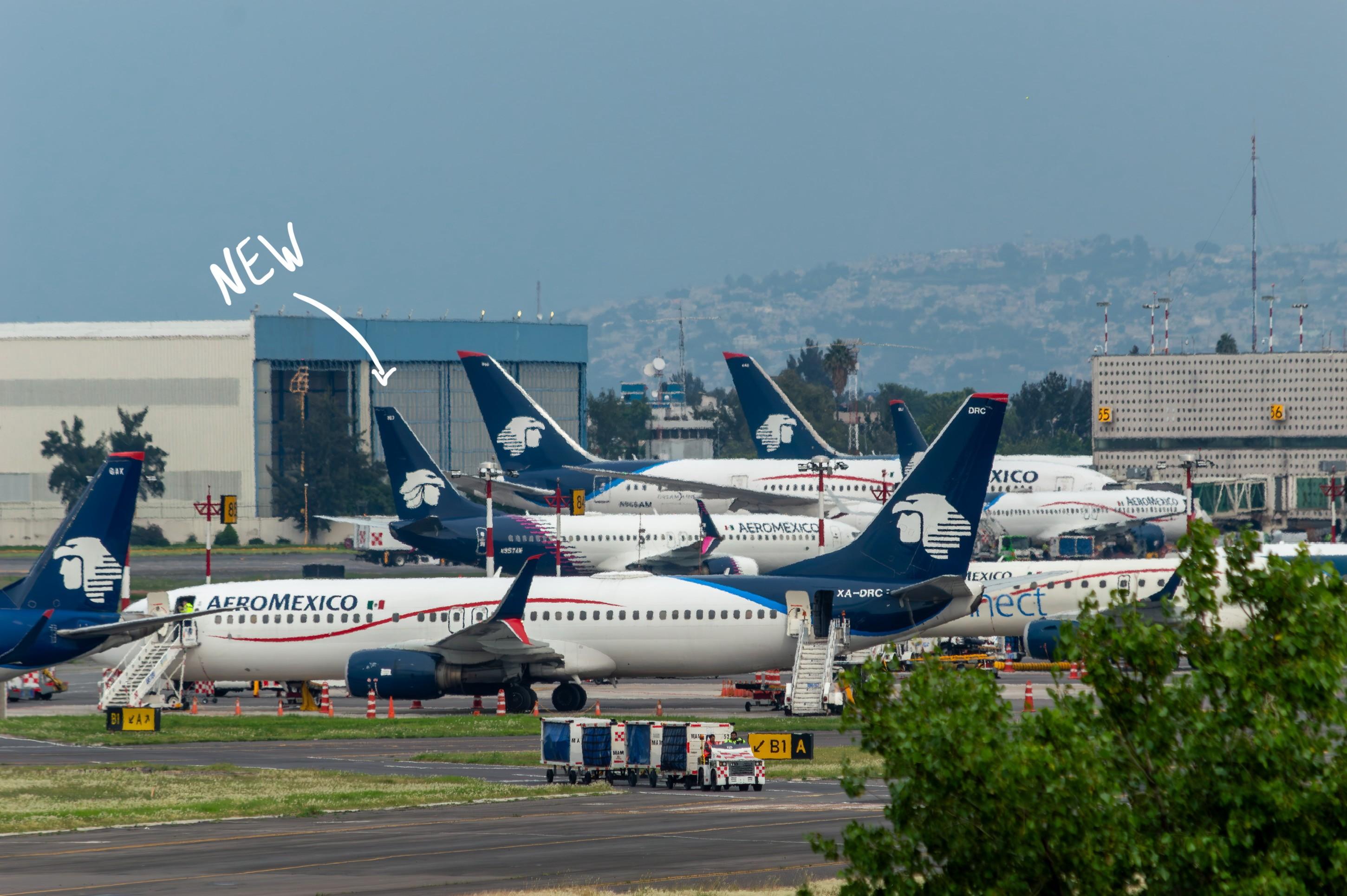 Aeromexico aircraft parked at the airport with an arrow highlighting the first plane painted in the new 2024 livery among older schemes
