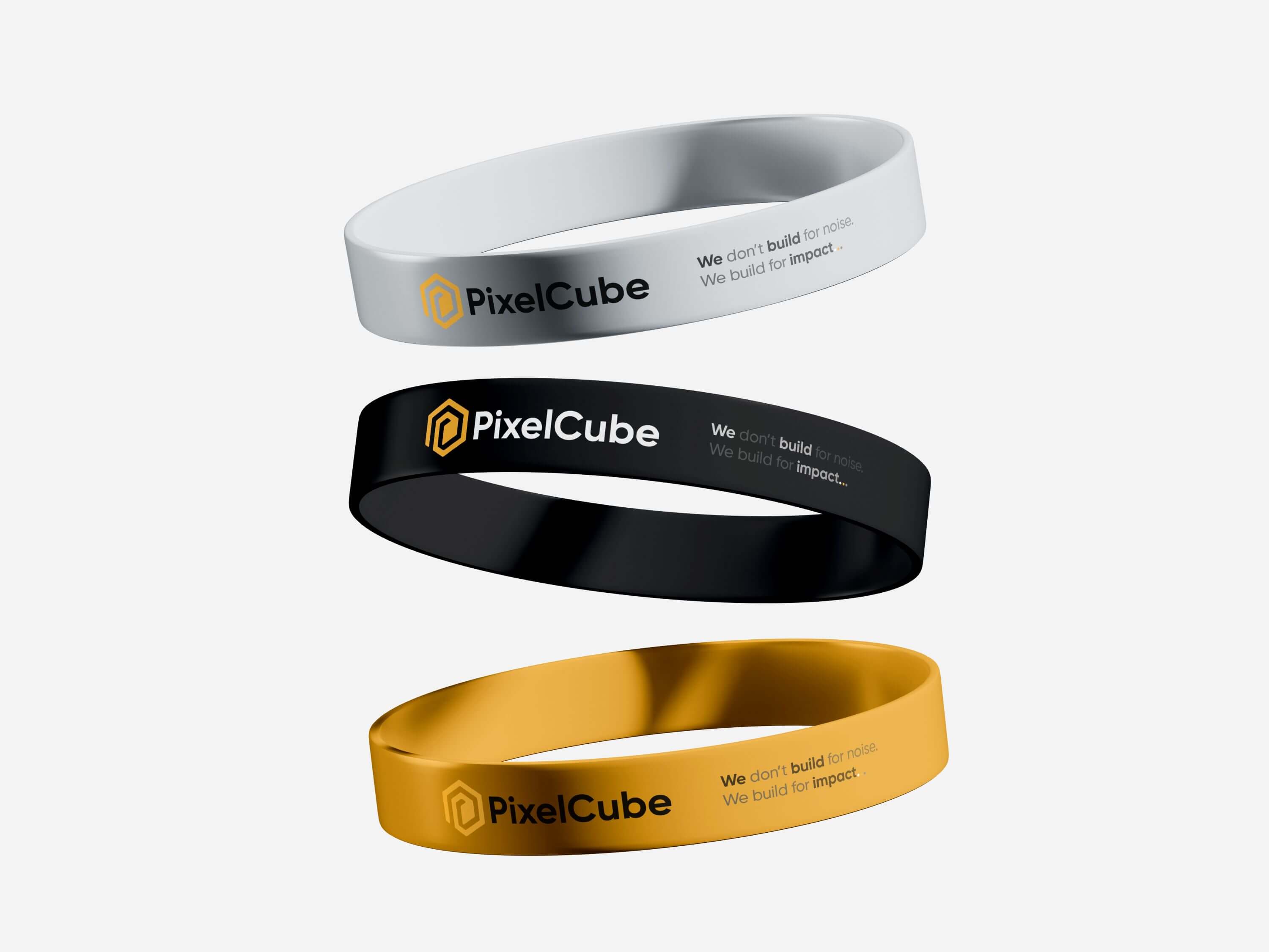 PixelCube branded silicone wristbands in white, black, and gold with modern corporate branding.