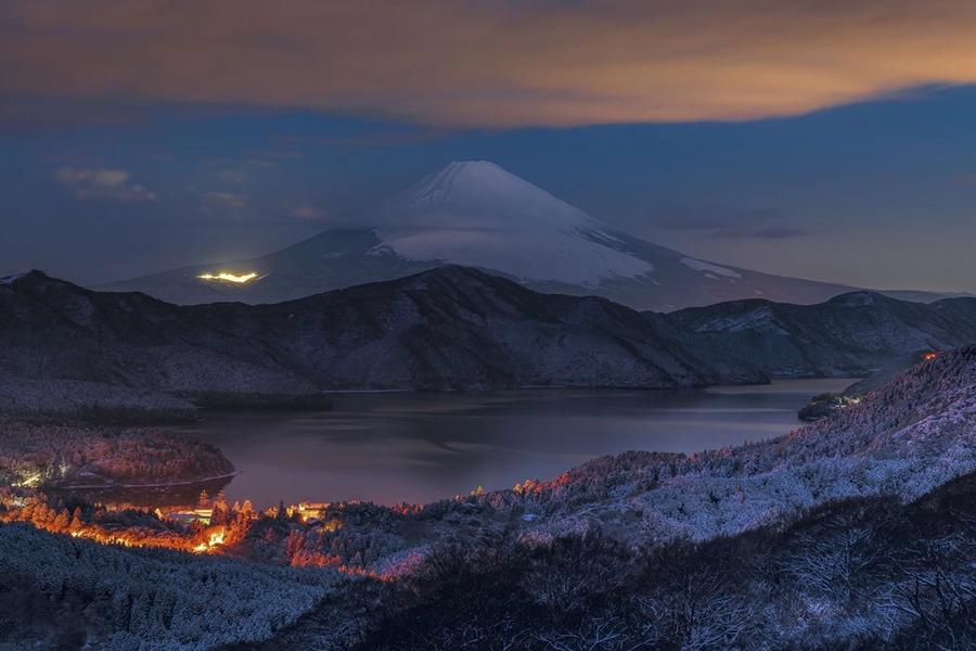 Person inspecting a used car before buying