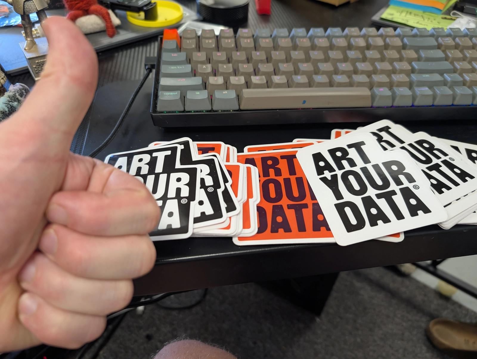 Art Your Data stickers and a thumbs up