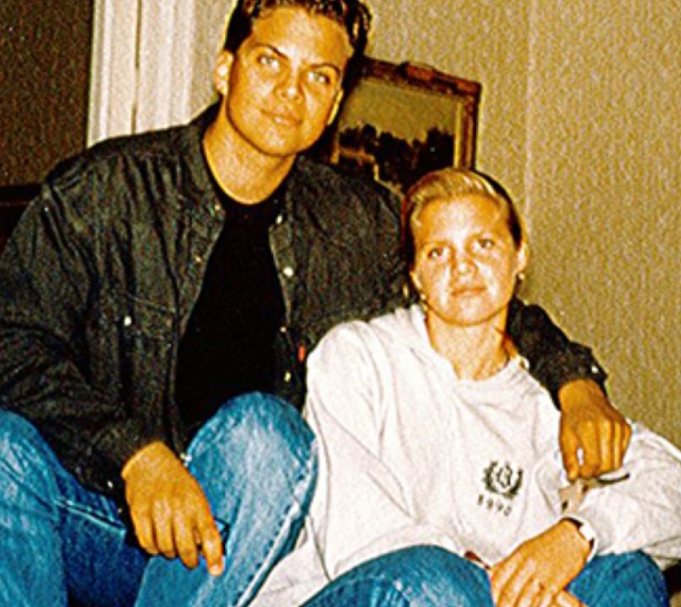 A man and a woman are sitting next to each other on a couch.