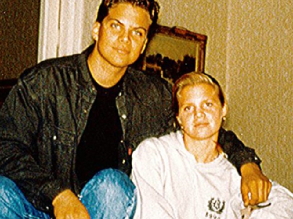 A man and a woman are sitting next to each other on a couch.