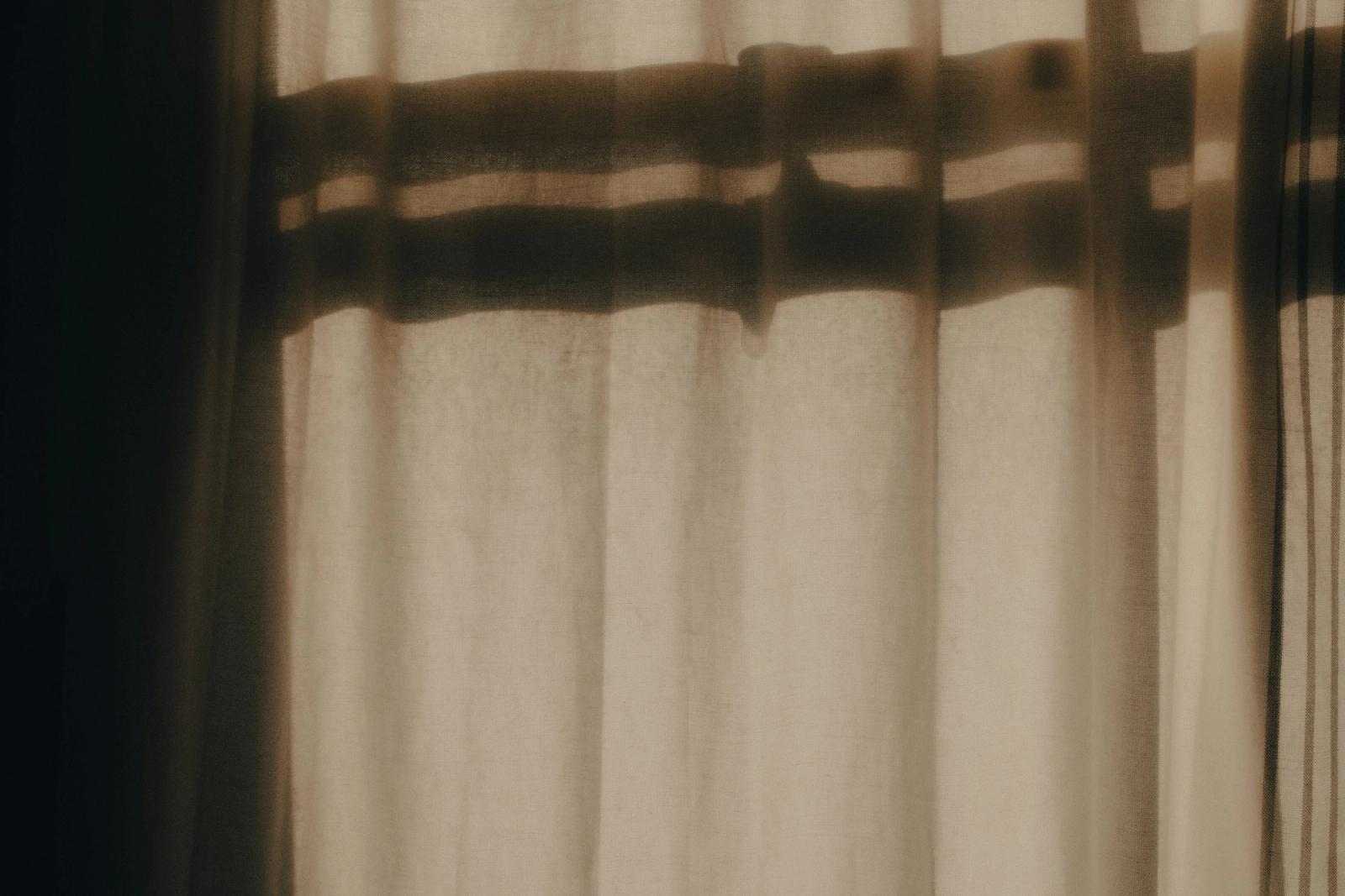 Soft shadows falling across a warm curtain.