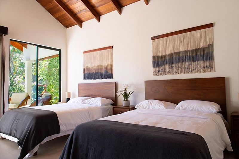 Shared-layout room with twin beds and natural light.