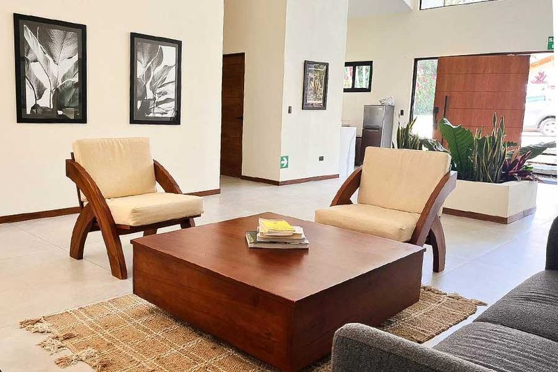 Living room with sofas and natural light at Riverside.