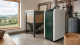 A biomass boiler and pellet storage setup in a rural British home plant room.