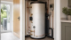Heat pump compatible hot water cylinder with neat pipework in a UK home utility cupboard.