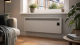 High heat retention electric storage heater with smart controls in a warm UK living room.