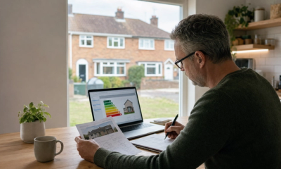 Homeowner reviewing an EPC and retrofit notes before applying for home energy grants