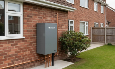 A Vaillant aroTHERM Plus R290 air source heat pump on a concrete plinth at the side of a UK 1980s red brick semi detached home, illustrating a properly sized retrofit heat pump installation.