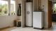 Modern British utility room with a compact heat battery unit and heating controls for a low carbon home upgrade.