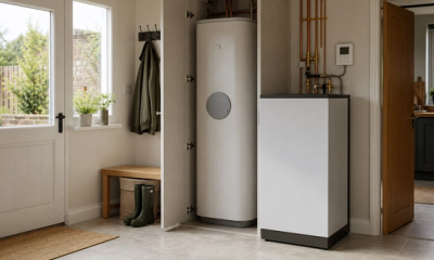 Modern British utility room with a compact heat battery unit and heating controls for a low carbon home upgrade.
