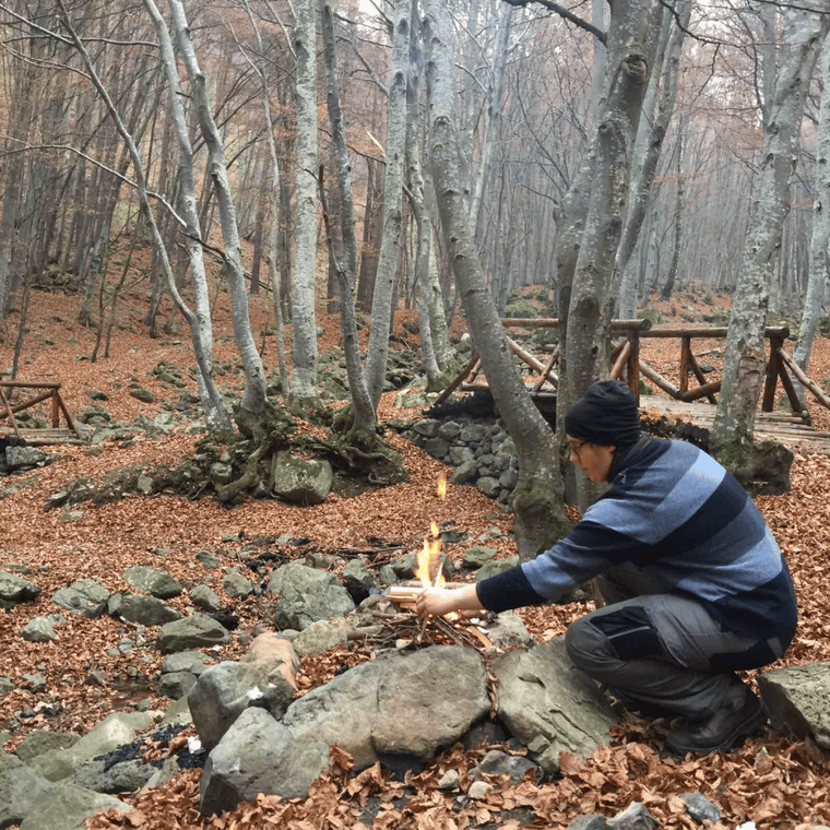 boy-setting-fire-in-woods
