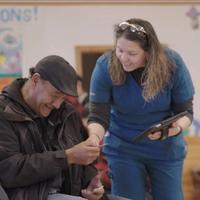 Woman helping smiling man