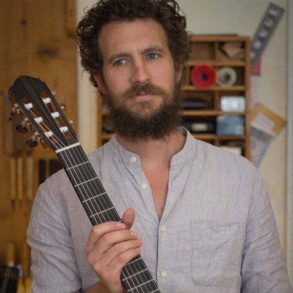 Photo du luthier Jasper Sender tenant une guitare classique nylon qu'il a fabriqué