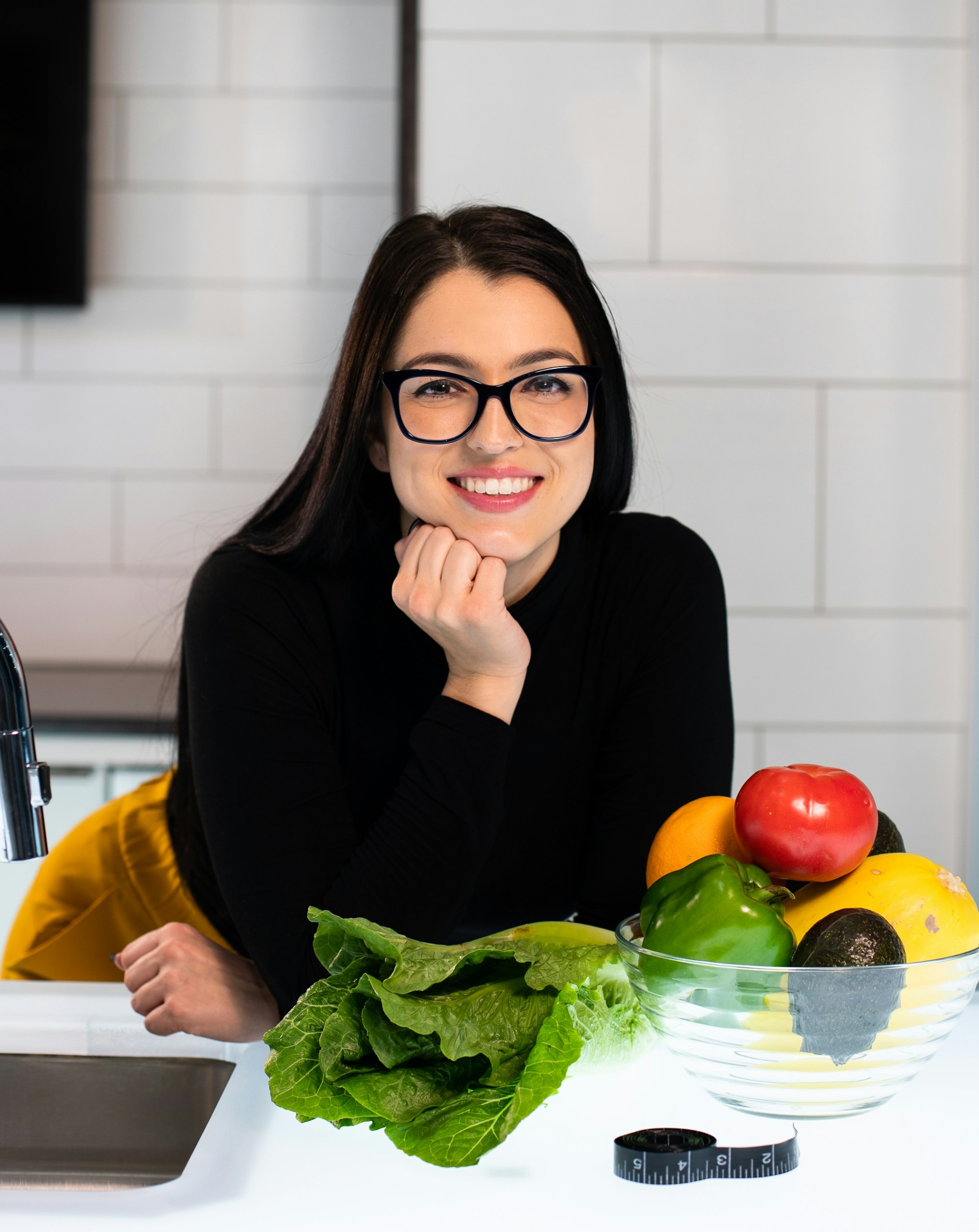 Nutritionist at a table with fresh fruit and vegetables