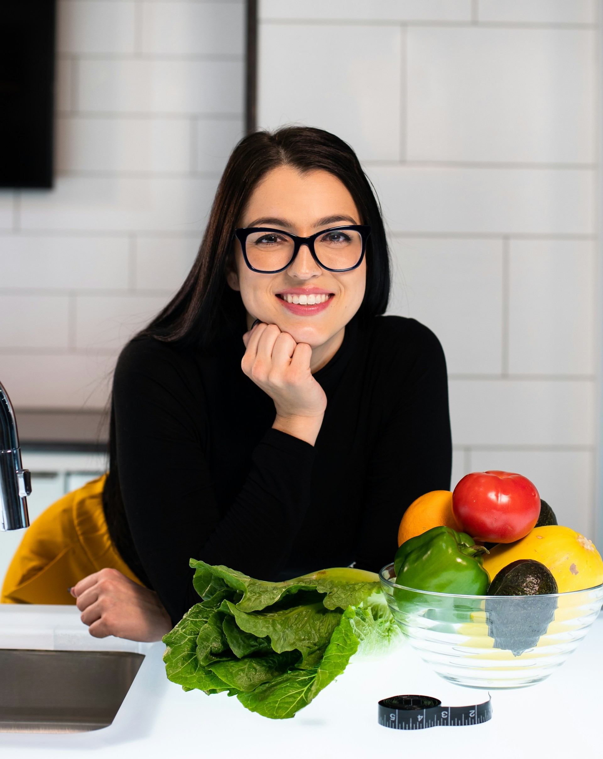 Nutritionist at a table with fresh fruit and vegetables