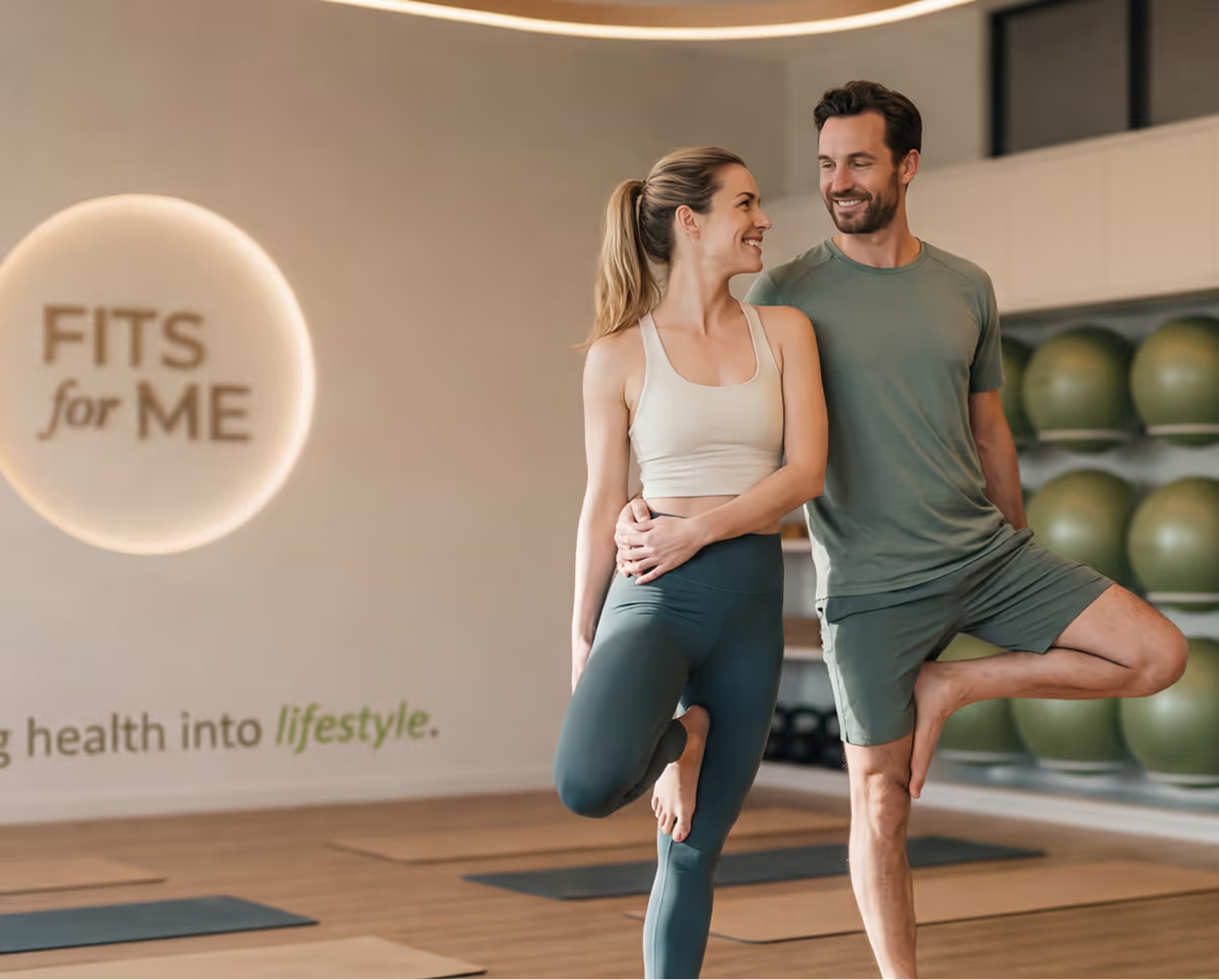 Two people standing relaxed in front of the branded studio wall