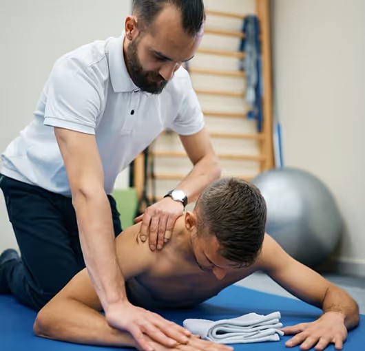 Health coach treating a client’s shoulder