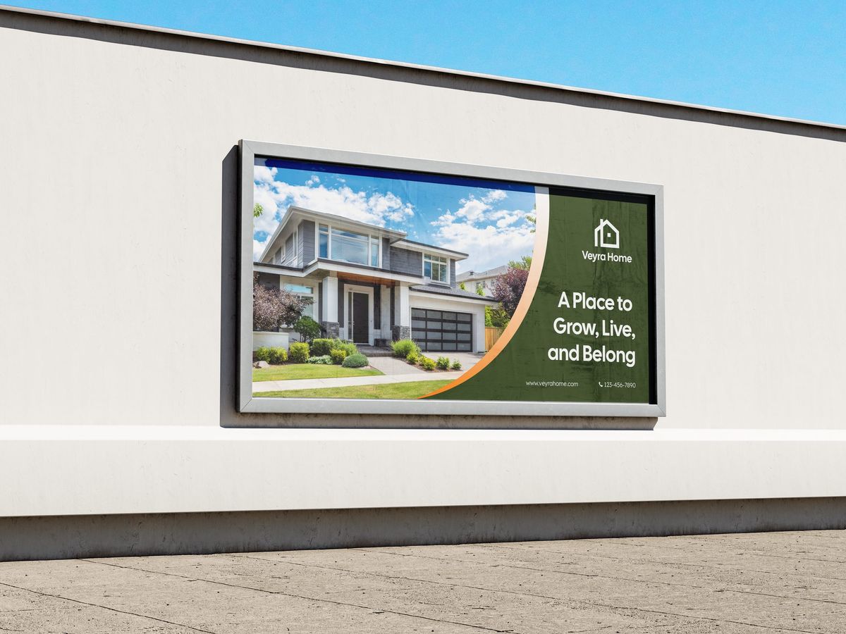 Wide outdoor sign print for a real estate brand, mounted on a wall