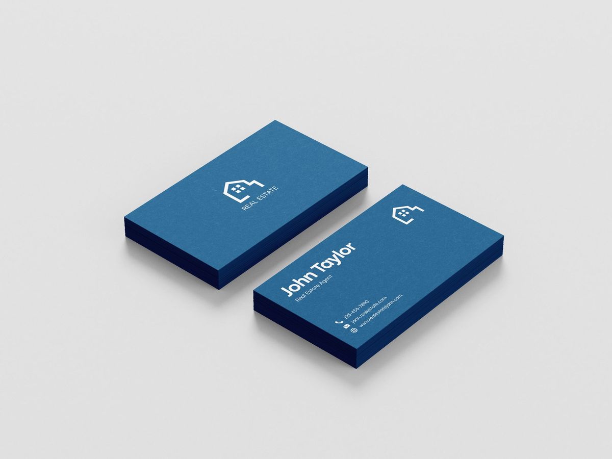 Two stacked navy business cards with embossed logo