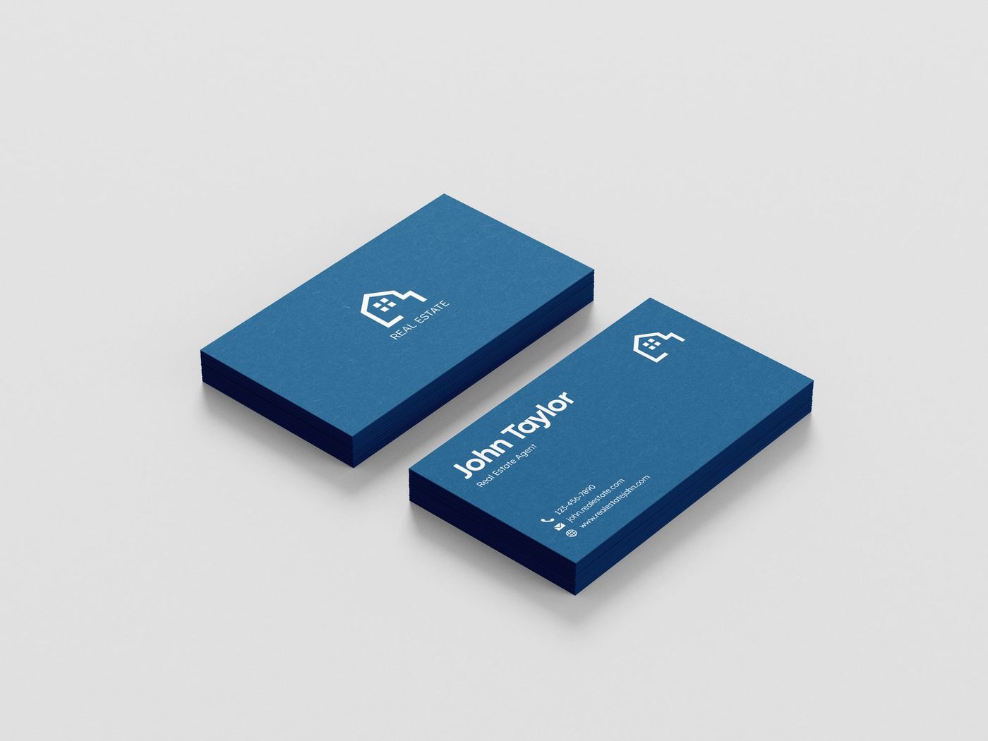 Two stacked navy business cards with embossed logo