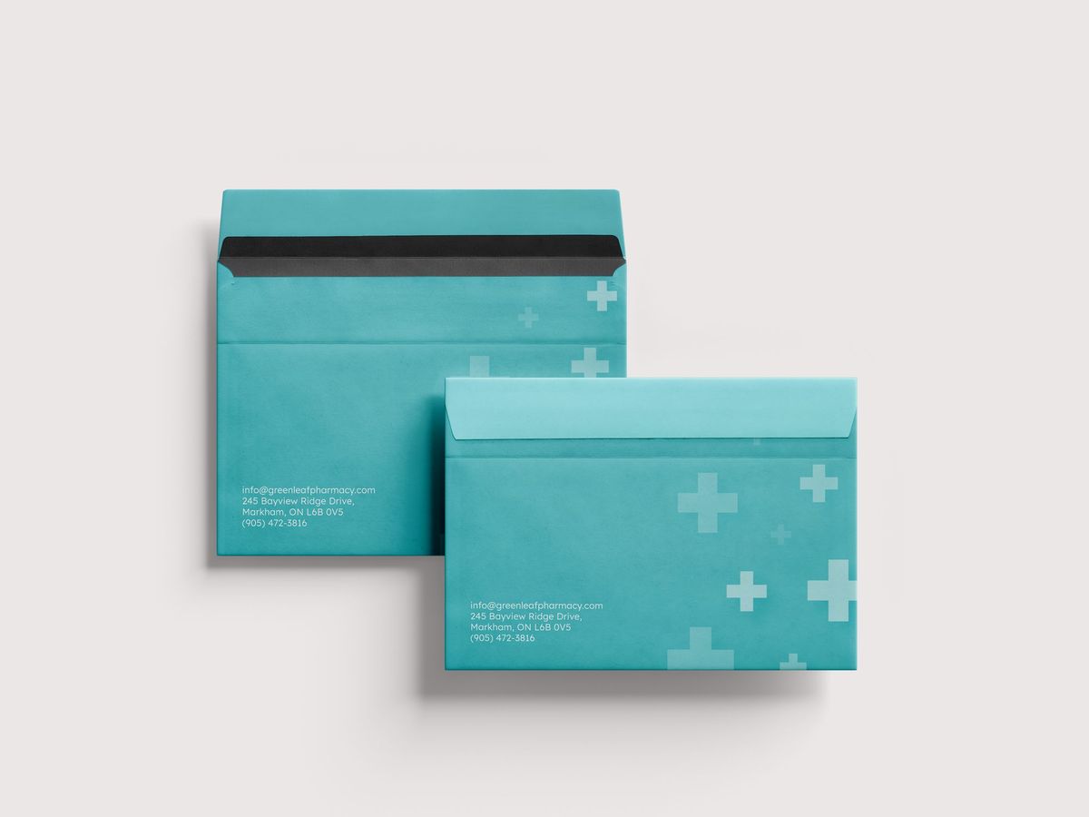 Custom printed teal envelopes with a pharmacy brand pattern, front and back