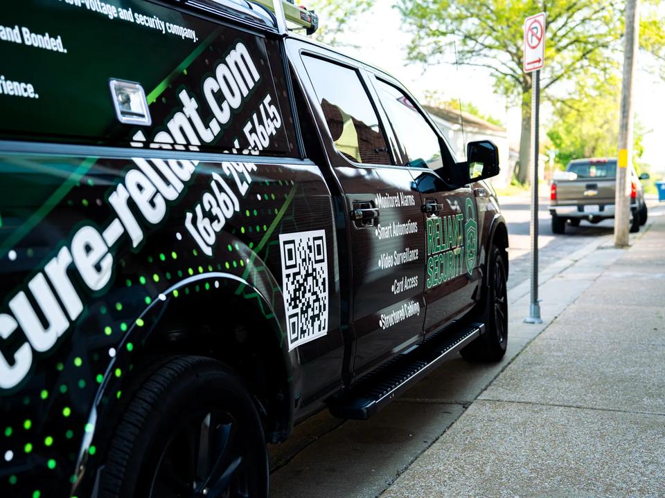 A branded Reliant Security service truck parked on a street in the St. Louis metro.