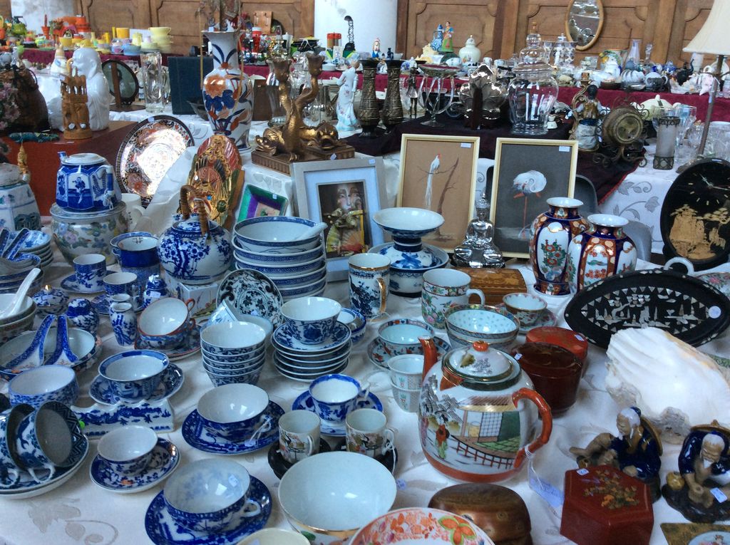 Table full of blue and white tableware, Asian vases and cups with saucers in the church