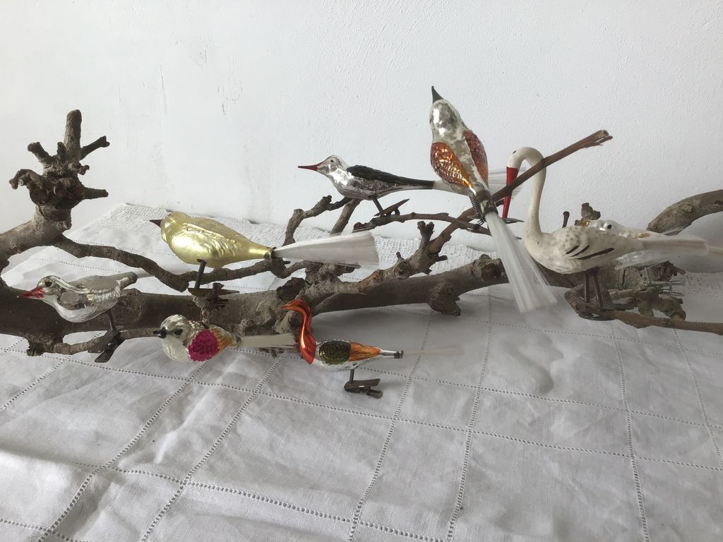 Glazen vogeltjes met staartveren en een zwaan op een tak