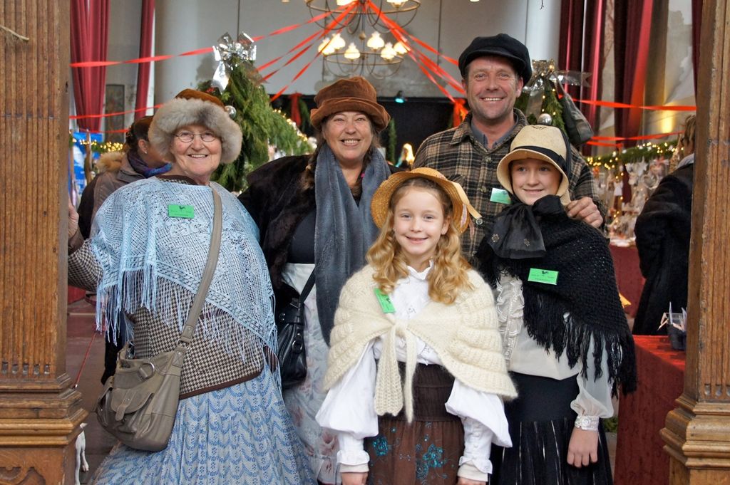 Family in Dickens clothing posing in the church