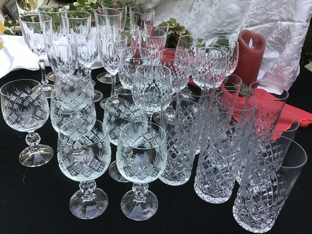 Cut crystal wine glasses and highball glasses on a table