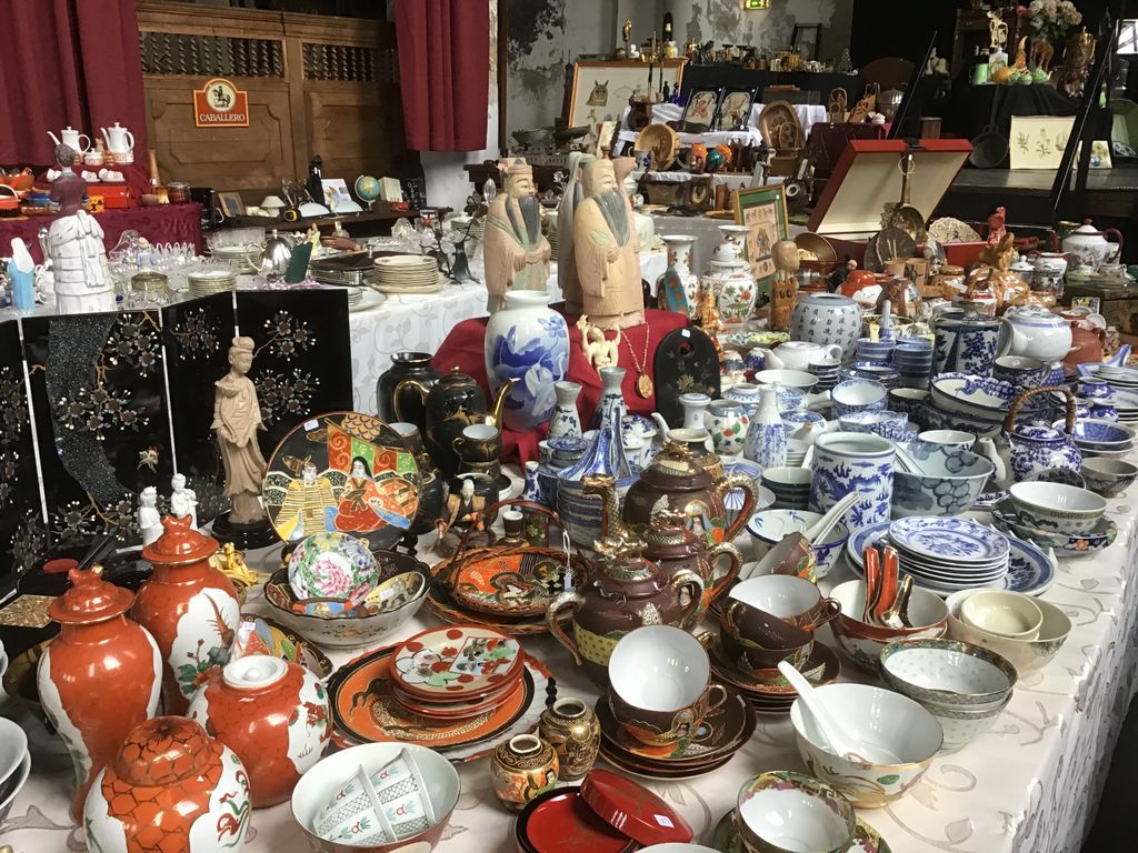 Table full of pottery, vases, teapots and Asian figurines