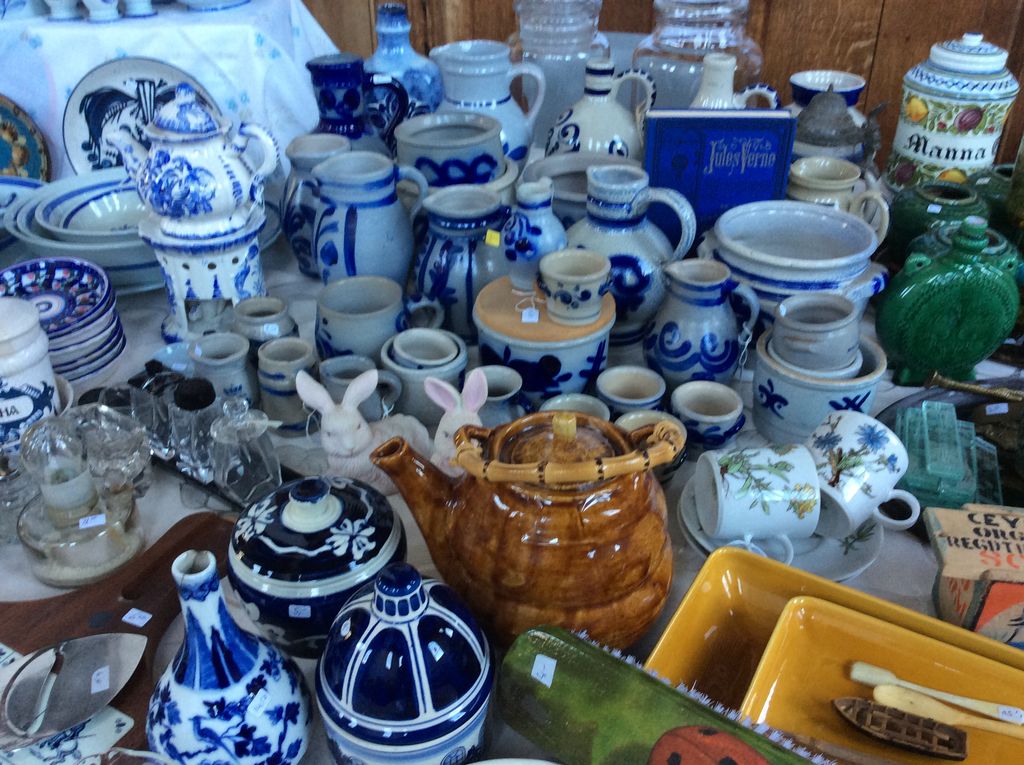 Blue and white stoneware, jugs and teapots, a brown teapot and yellow oven dishes