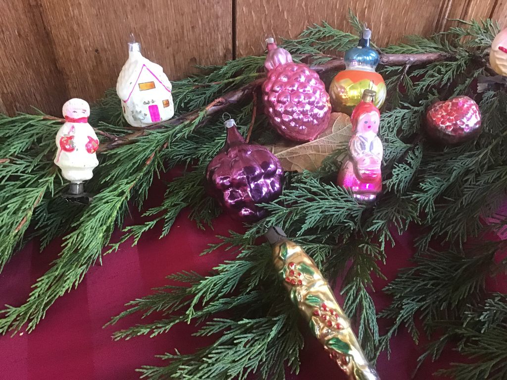 Antieke glazen hangers: druiventros, sneeuwpopje, huisje en ijspegel op dennentakken