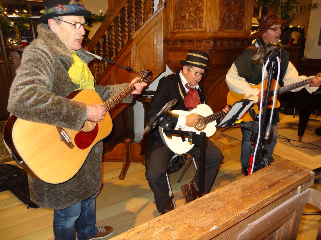 Three musicians with guitars playing in the church