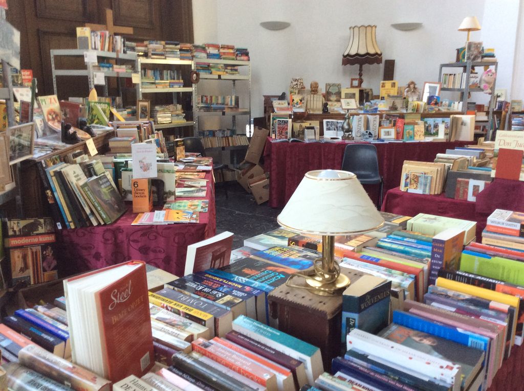 Tables full of books with a table lamp in the church