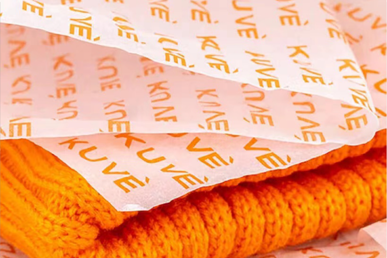 Pink tissue paper with repeating logo pattern