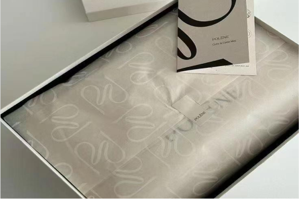 White-on-white printed tissue paper inside Polène packaging box