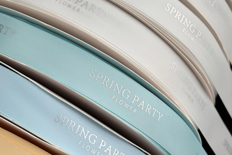 Foil stamped ribbon sample with metallic logo finish