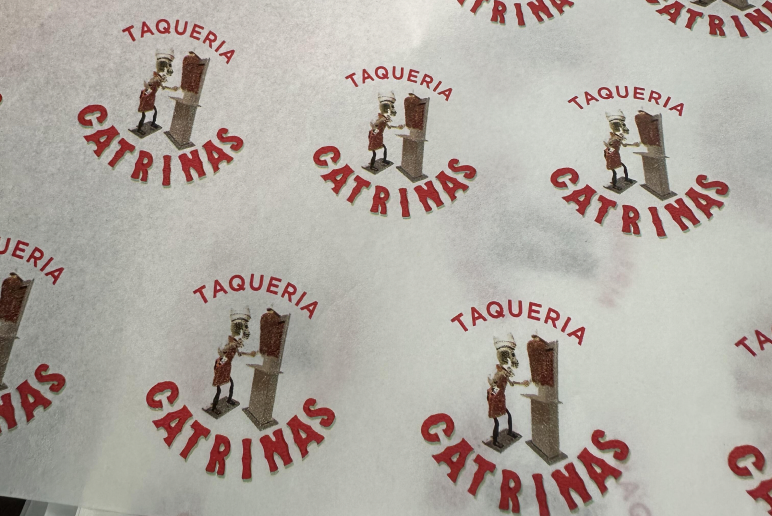 White tissue paper with repeating red circular logo print