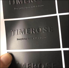 Matte black vinyl sticker label with raised logo