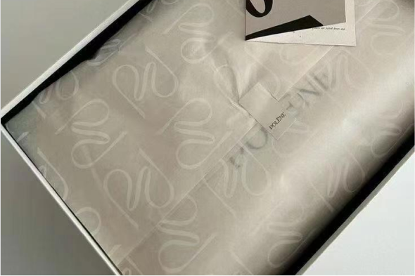 Polène custom white tissue paper with repeated tone-on-tone logo pattern