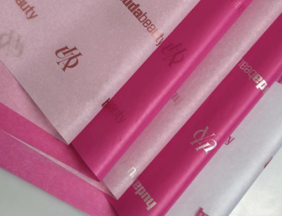 Pink custom printed tissue paper sheets with repeated brand logos