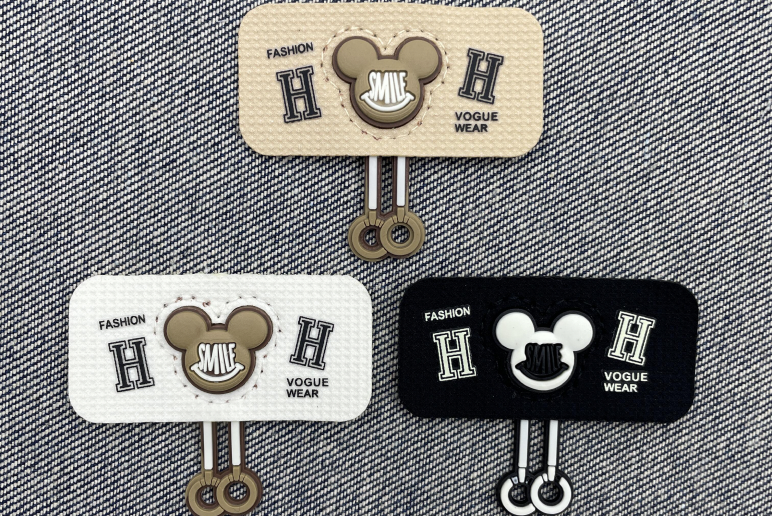 Leather and woven label materials displayed on denim