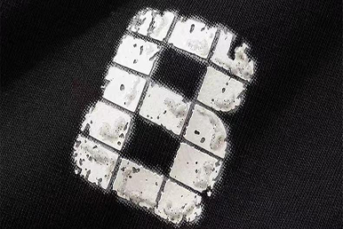 Distressed white screen-printed logo on black fabric for custom cotton dust bags